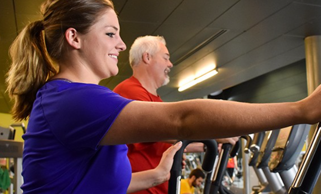 woman and man on ellipticals